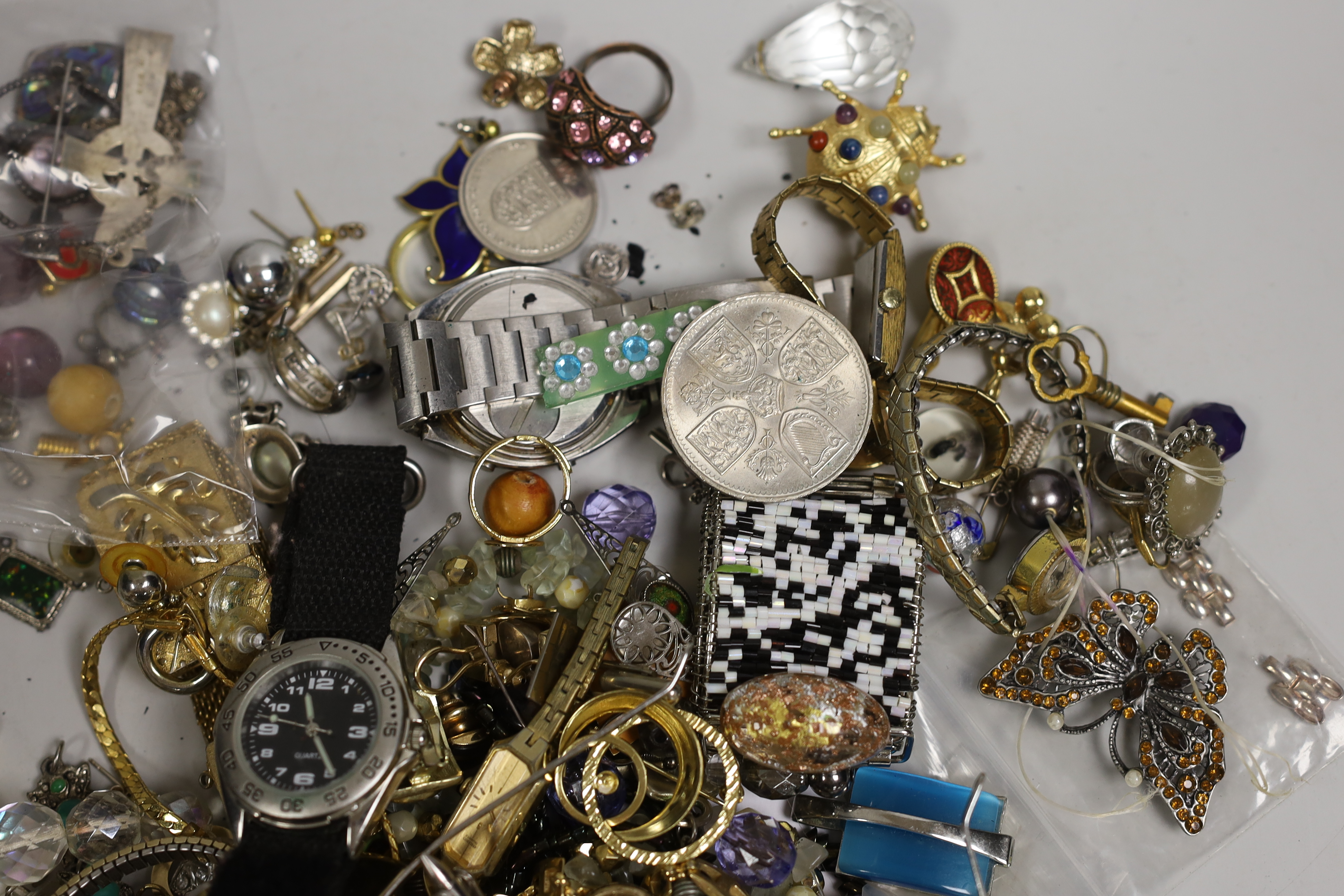 A box of costume jewellery including silver brooches and pendants.